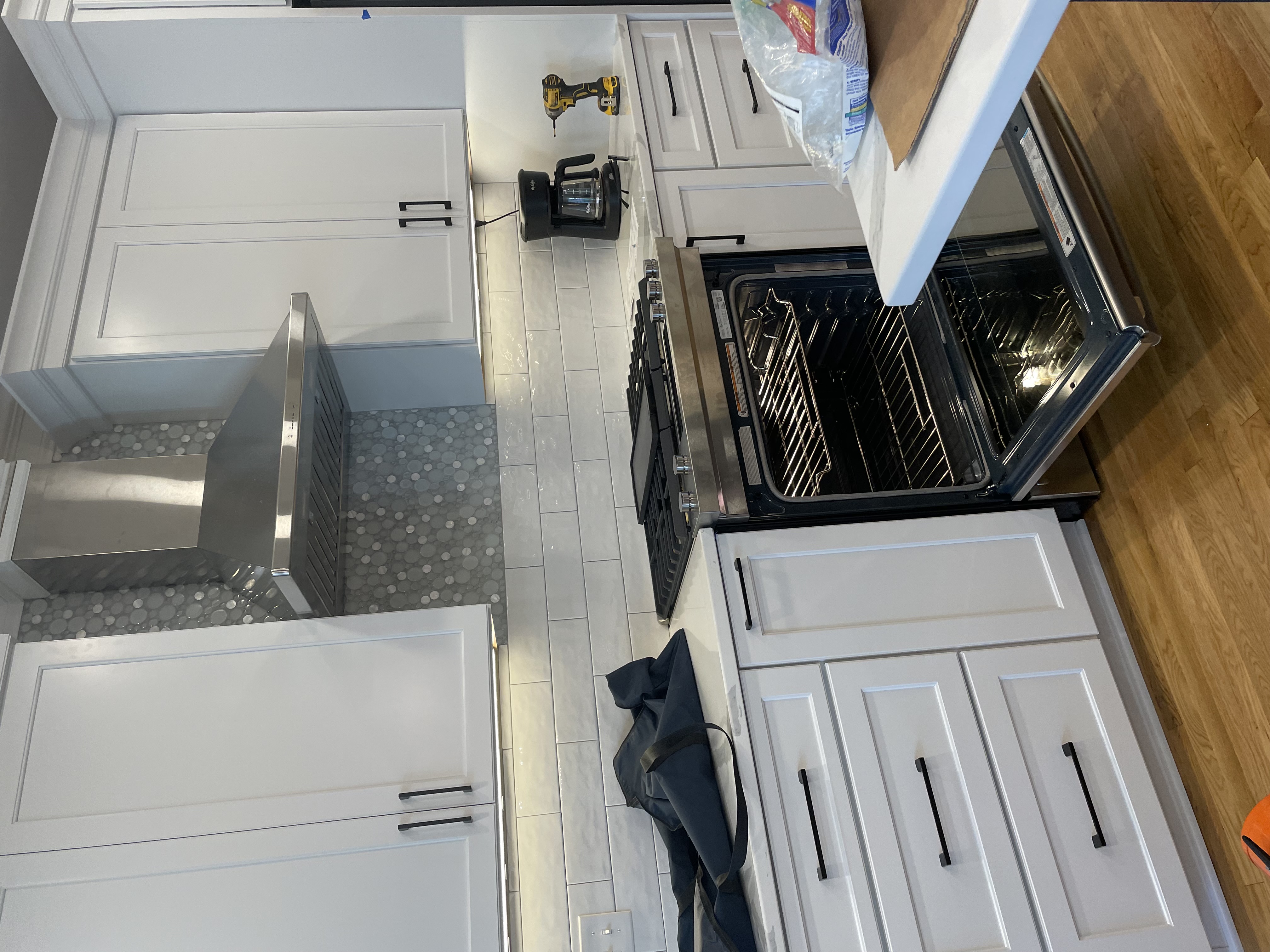 Stainless steel range hood installed in a remodeled kitchen