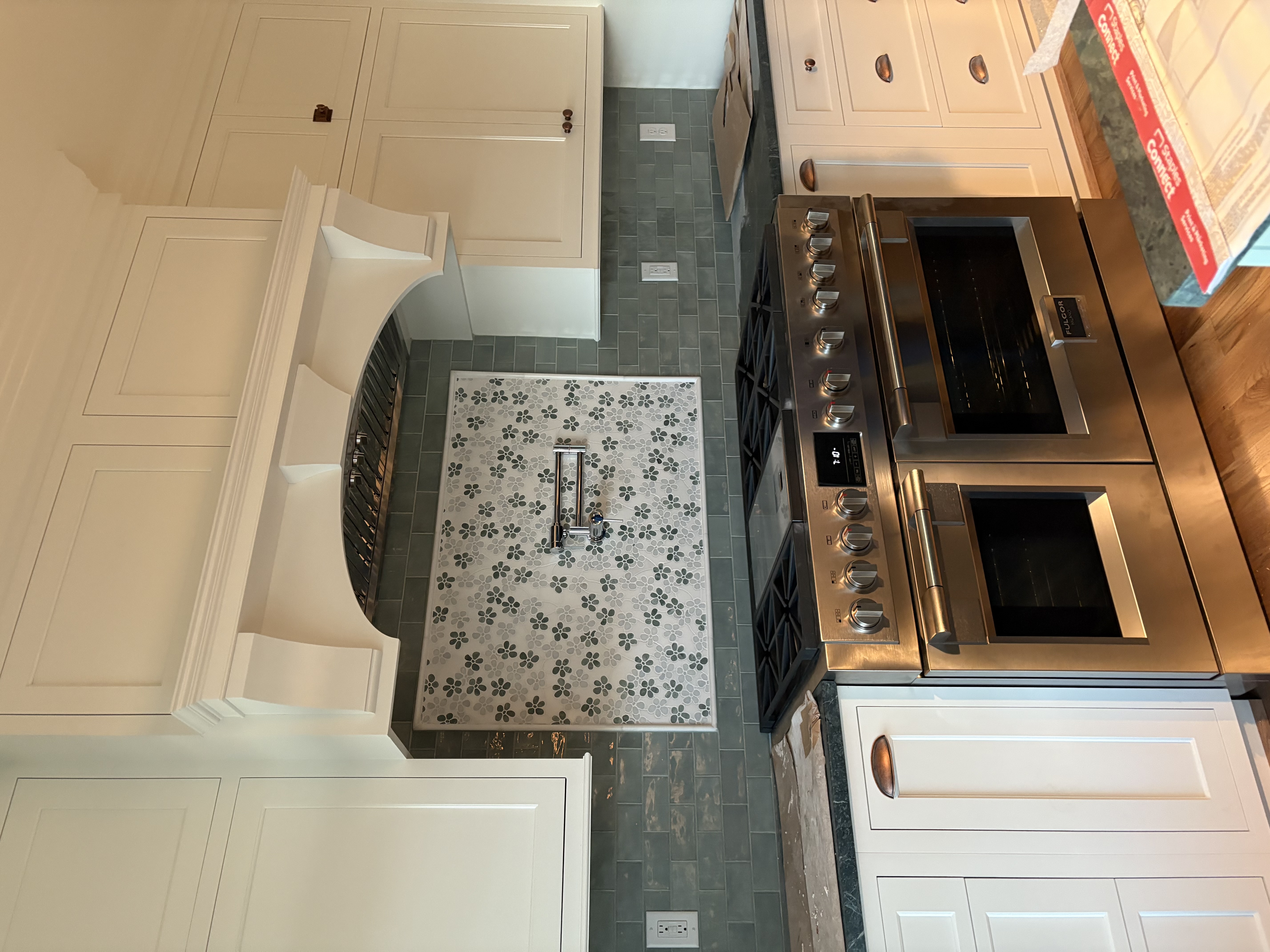 Stainless steel gas range with double oven installed in a kitchen