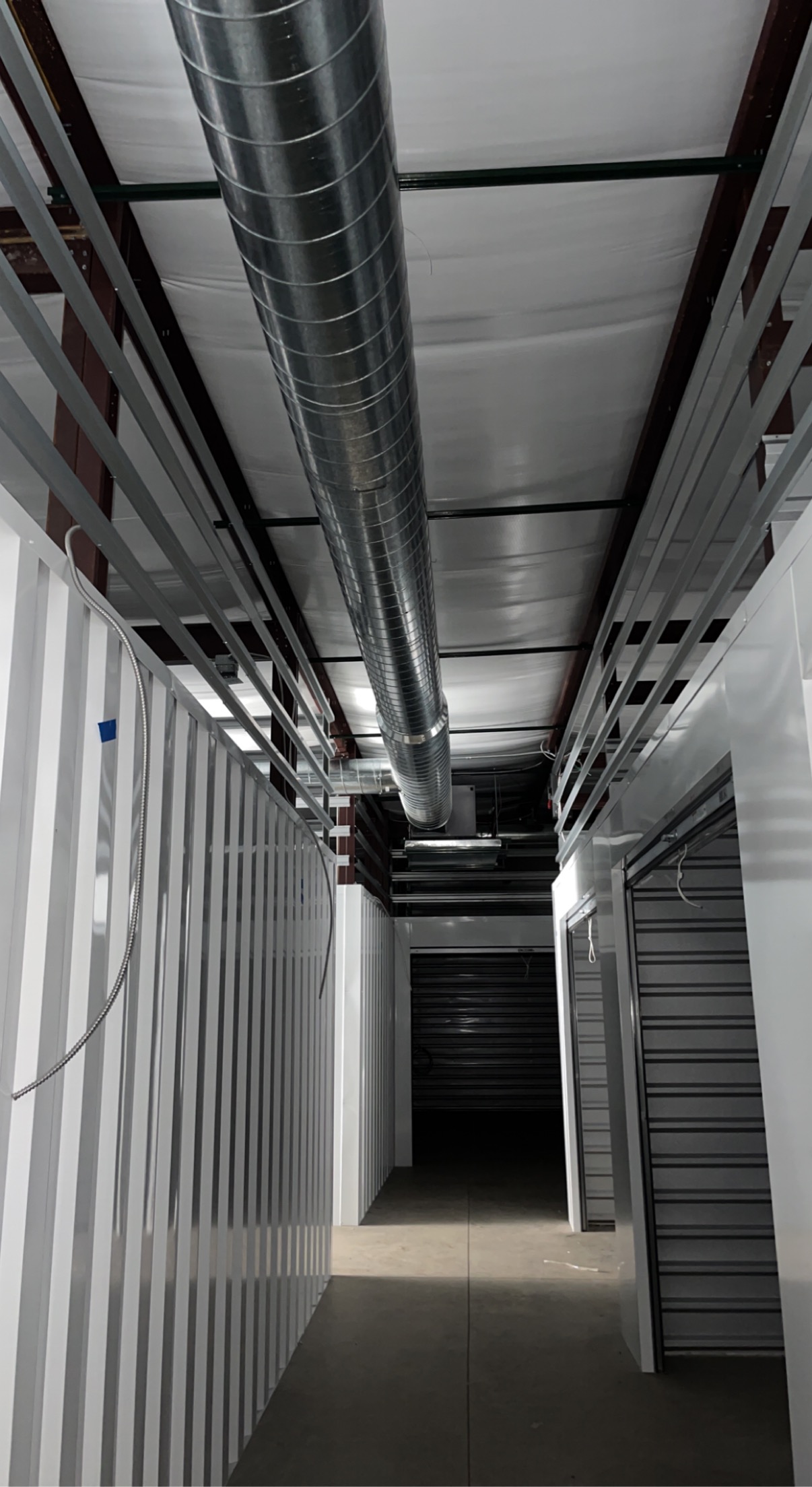 Spiral metal ductwork running through a commercial storage facility